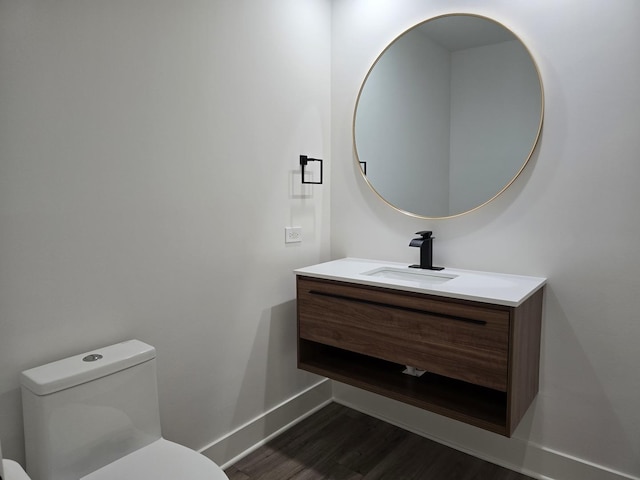 bathroom with vanity, hardwood / wood-style floors, and toilet