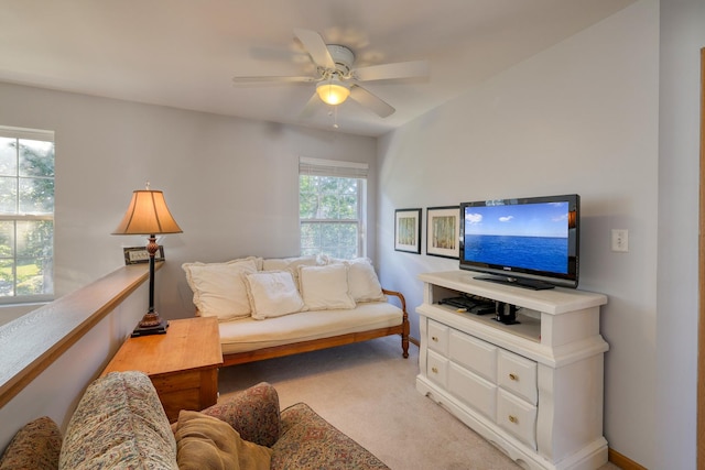 carpeted living room featuring ceiling fan