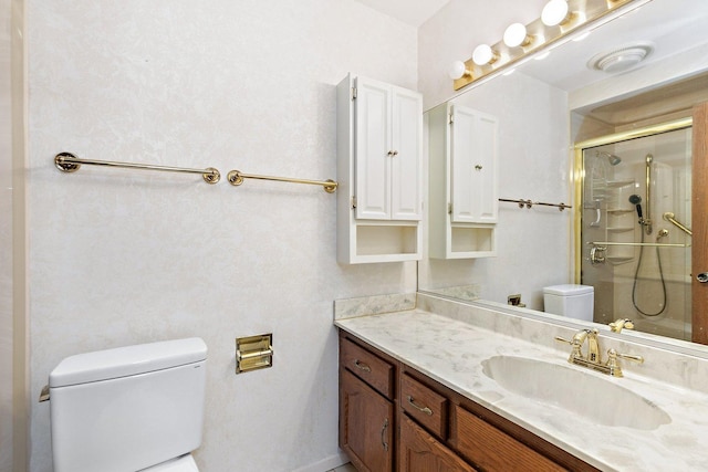 full bath featuring toilet, vanity, and a shower with shower door