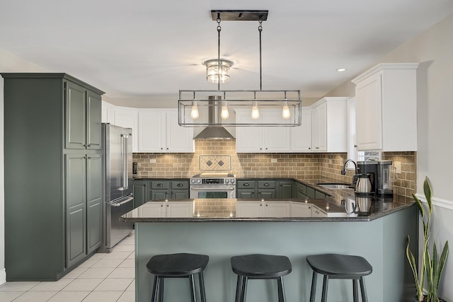 kitchen with pendant lighting, stainless steel appliances, backsplash, and white cabinets