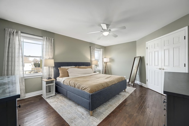 bedroom with dark hardwood / wood-style flooring, a closet, and ceiling fan