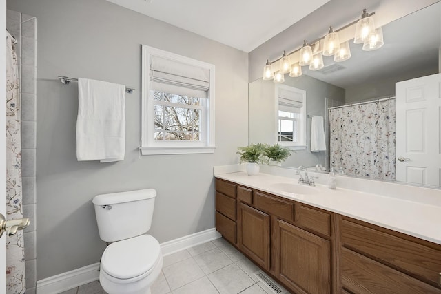 bathroom featuring vanity, toilet, and tile patterned flooring