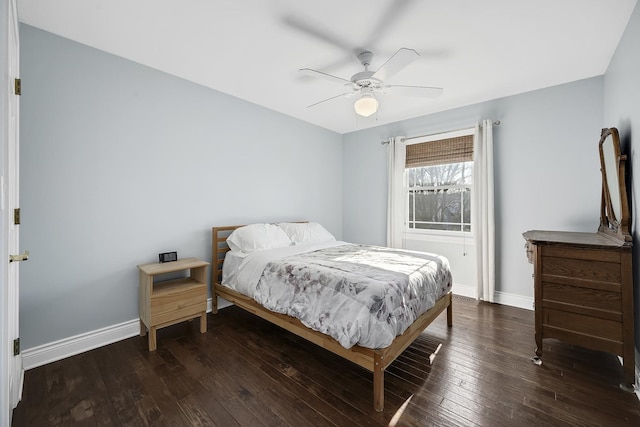 bedroom with dark hardwood / wood-style floors and ceiling fan