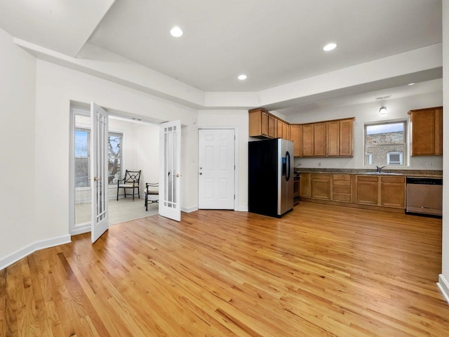 kitchen with sink, light wood-type flooring, and stainless steel appliances