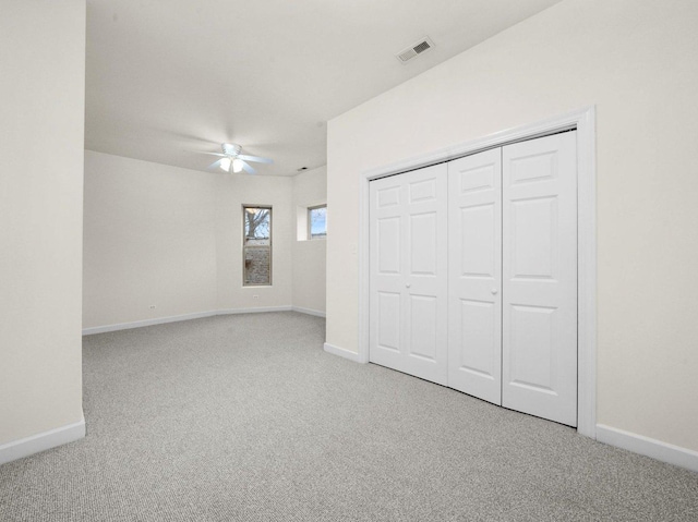 unfurnished bedroom featuring light colored carpet and ceiling fan