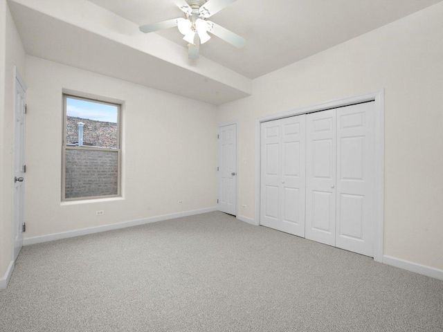 unfurnished bedroom featuring a closet, ceiling fan, and carpet floors