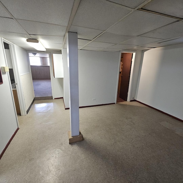 basement with a paneled ceiling