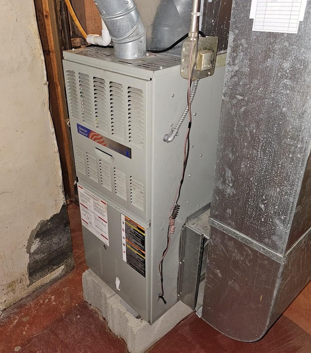 utility room featuring heating unit