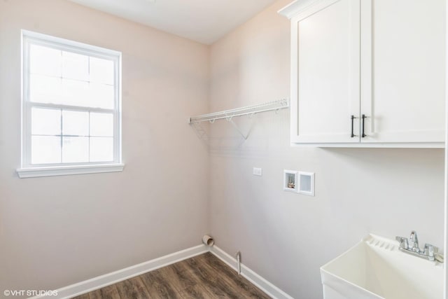 laundry area with sink, dark hardwood / wood-style floors, cabinets, and washer hookup