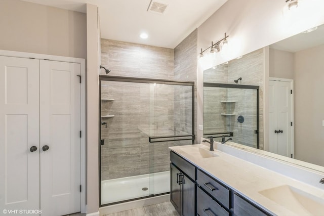 bathroom with vanity and an enclosed shower