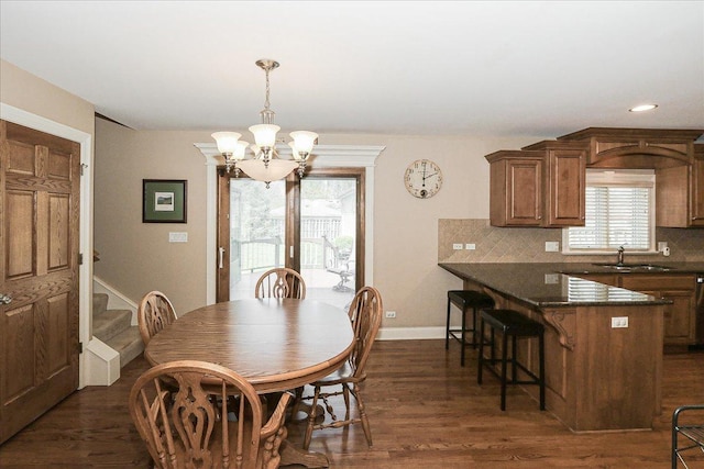 dining space with recessed lighting, baseboards, dark wood finished floors, and a notable chandelier