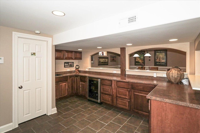 bar featuring beverage cooler, recessed lighting, visible vents, and dark tile patterned flooring