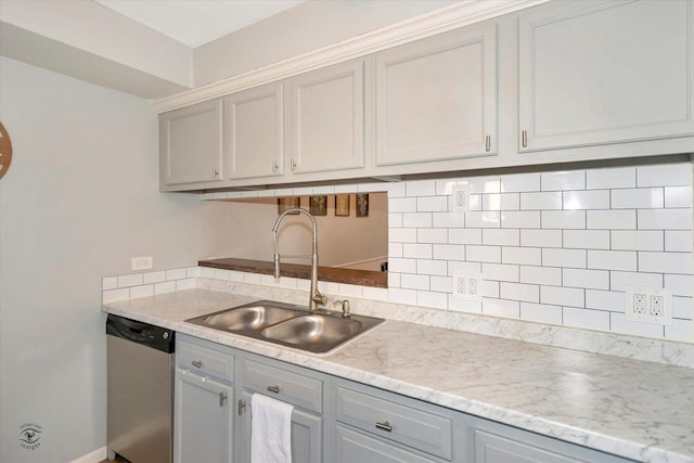 kitchen with sink, dishwasher, gray cabinetry, and tasteful backsplash