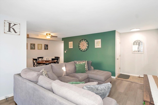 living room with ceiling fan and light wood-type flooring