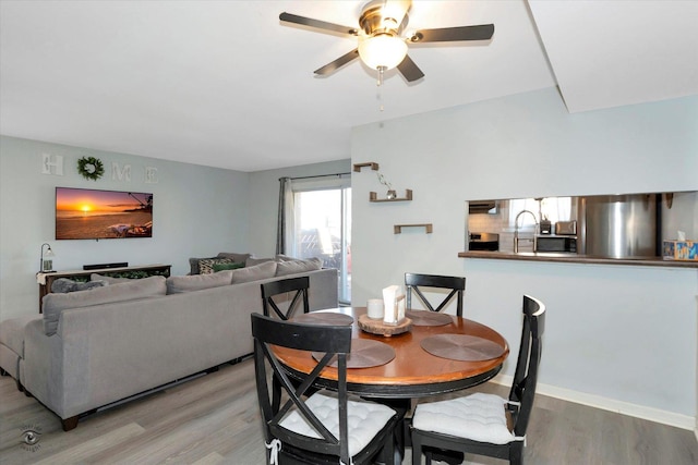 dining area with hardwood / wood-style flooring and ceiling fan