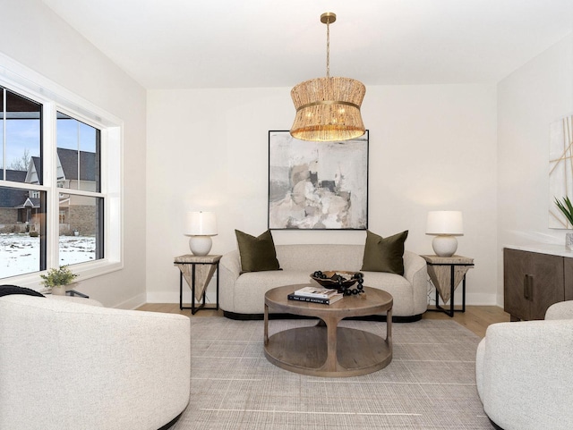 living area featuring wood-type flooring and a notable chandelier