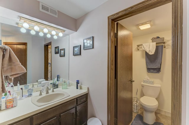 bathroom with toilet and vanity