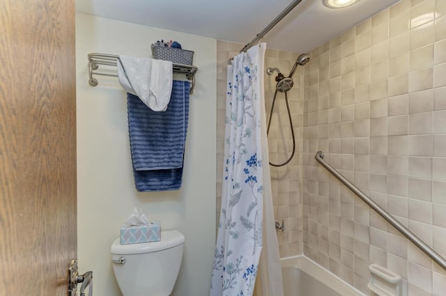 bathroom with shower / bath combo and toilet