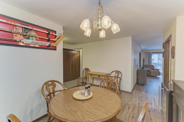 dining room with a chandelier and light wood-type flooring