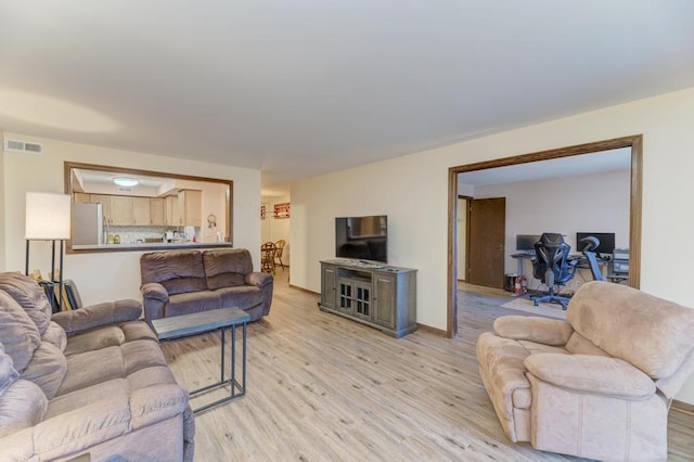 living room with light hardwood / wood-style floors