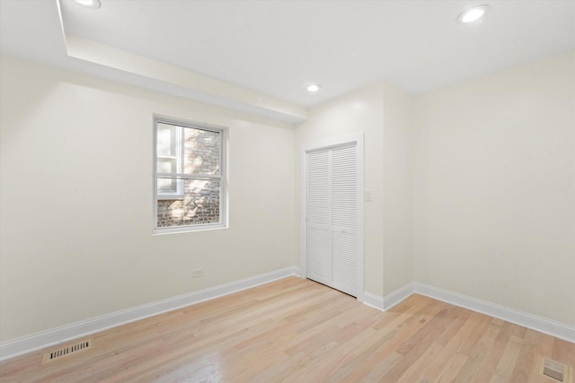 unfurnished bedroom with light hardwood / wood-style floors and a closet