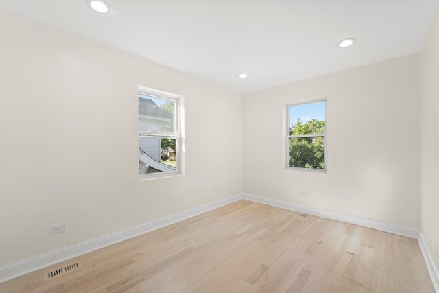 unfurnished room with light hardwood / wood-style flooring