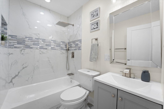 full bathroom featuring toilet, vanity, and tiled shower / bath