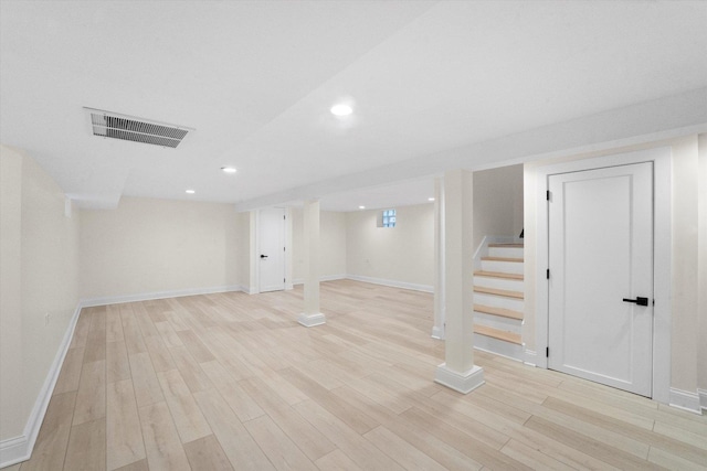 basement with light hardwood / wood-style floors