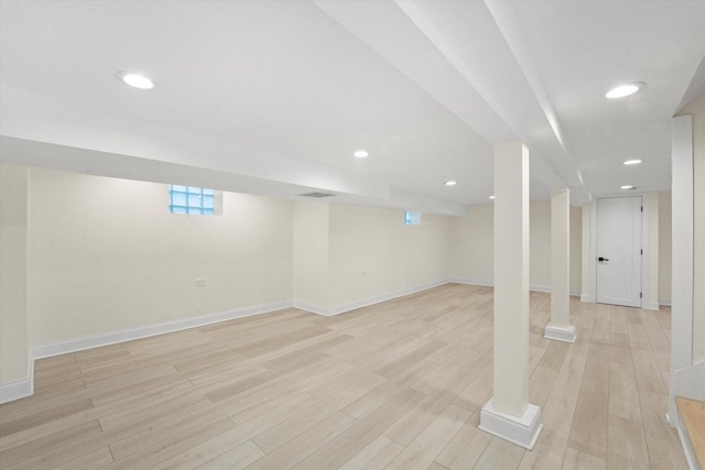 basement with light hardwood / wood-style flooring