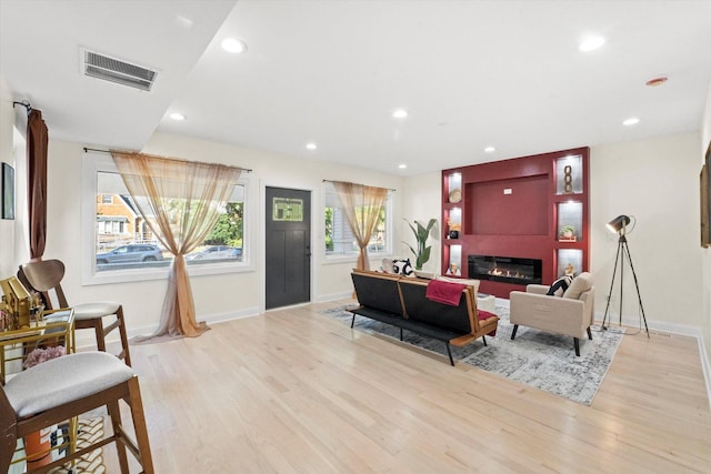 living room with a fireplace and light hardwood / wood-style floors