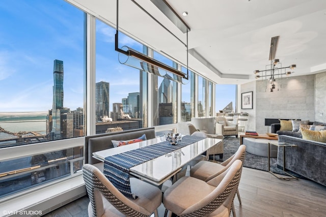 dining area featuring a chandelier, a water view, and light hardwood / wood-style flooring