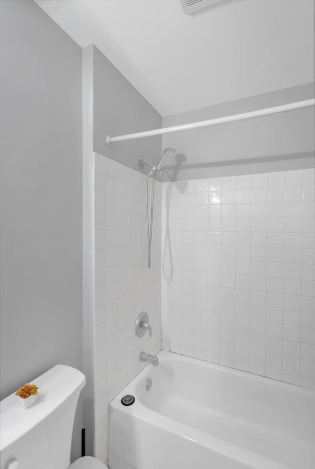 bathroom featuring shower / bathtub combination and toilet