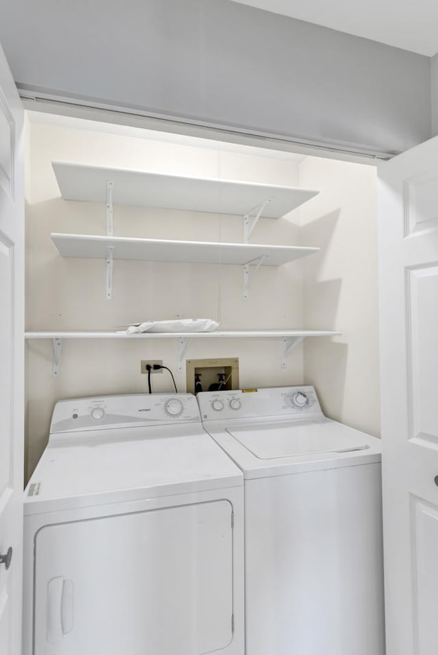 clothes washing area featuring washer and clothes dryer