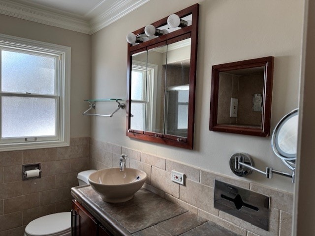 bathroom featuring toilet, vanity, tile walls, and crown molding