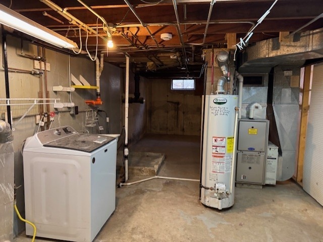 basement with water heater and washer / dryer