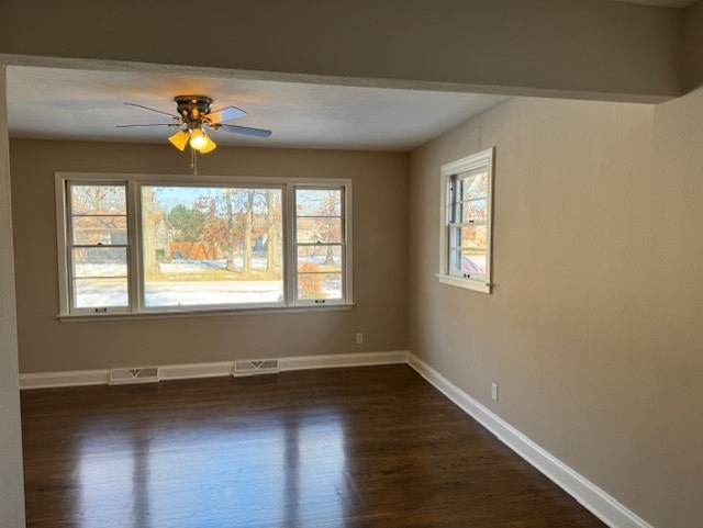 empty room featuring ceiling fan and dark hardwood / wood-style floors