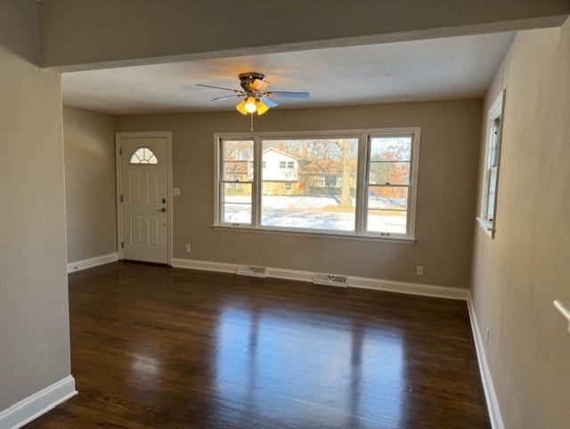 foyer entrance featuring ceiling fan and dark wood-type flooring