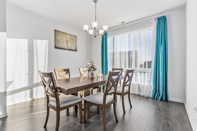 dining room featuring dark hardwood / wood-style floors and a chandelier