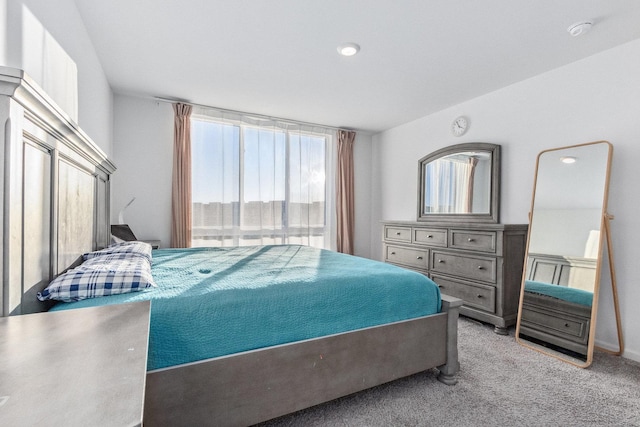 carpeted bedroom featuring multiple windows