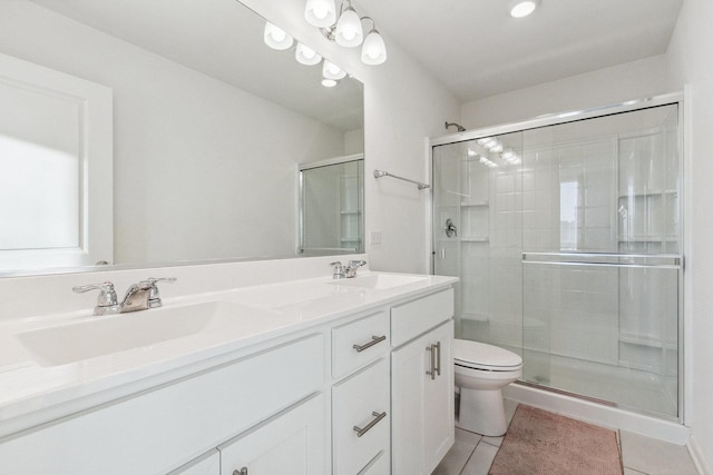 bathroom featuring vanity, toilet, a shower with shower door, and tile patterned flooring