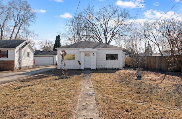 view of front of home with a front lawn and an outdoor structure