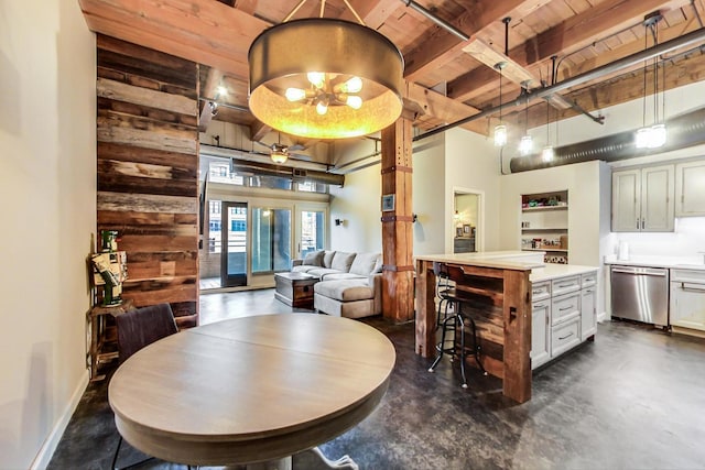 dining space featuring wood ceiling, beam ceiling, and a towering ceiling