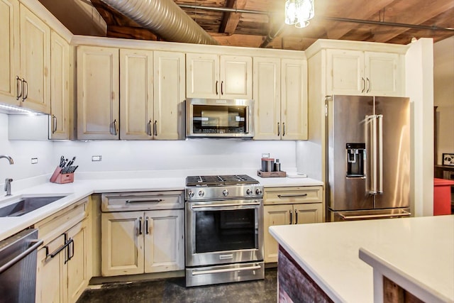 kitchen featuring sink, appliances with stainless steel finishes, and cream cabinets