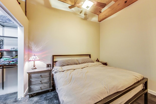 bedroom featuring ceiling fan and beam ceiling