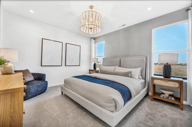 bedroom featuring light carpet and a chandelier