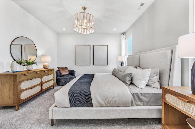 bedroom featuring light carpet and a chandelier