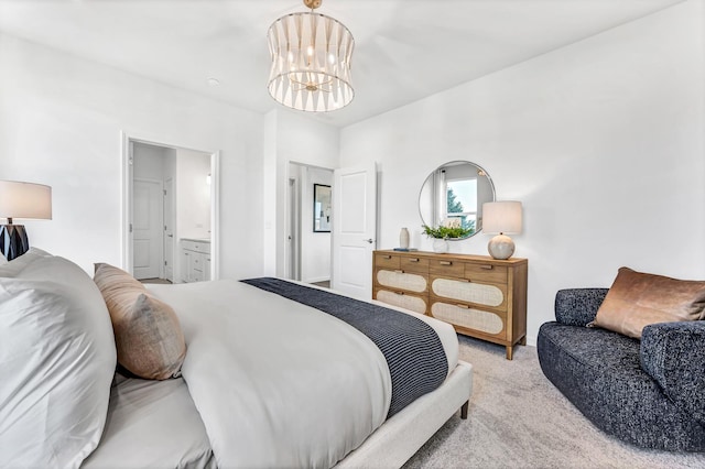 bedroom featuring light carpet, ensuite bath, and a notable chandelier