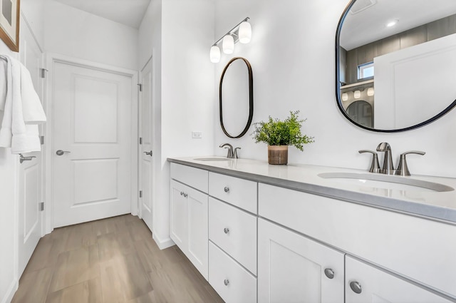 bathroom with hardwood / wood-style floors and vanity