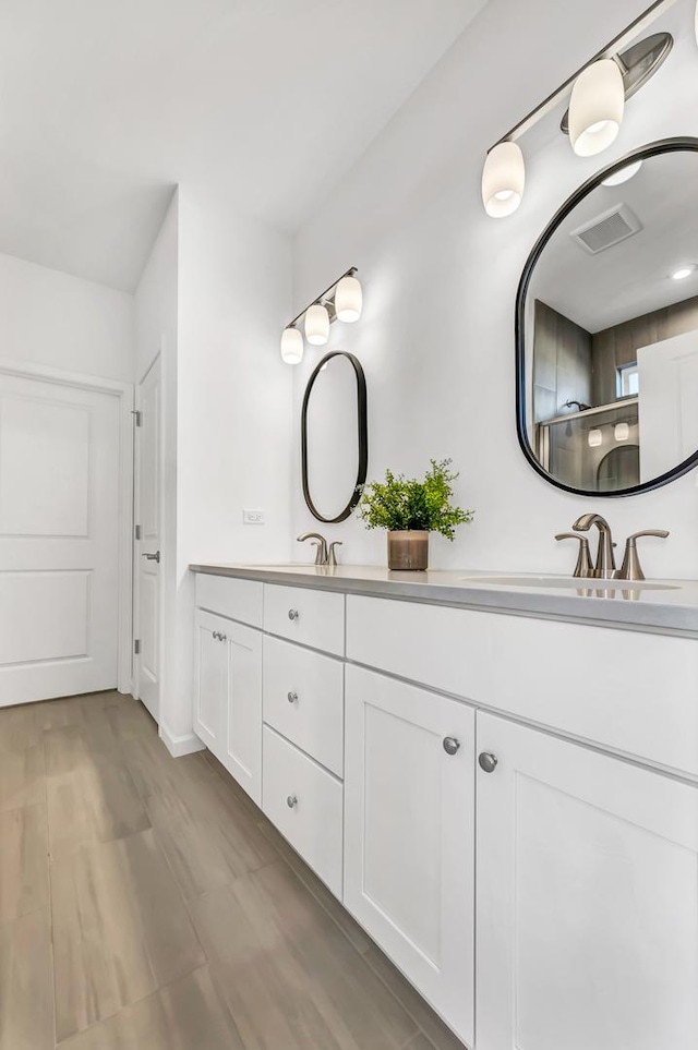 bathroom with vanity and hardwood / wood-style floors