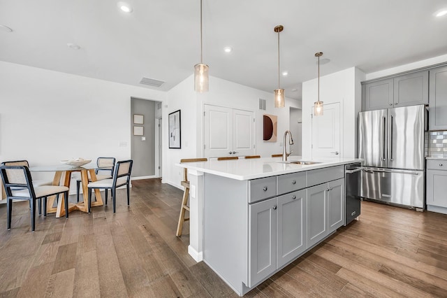 kitchen featuring sink, gray cabinetry, and high end refrigerator